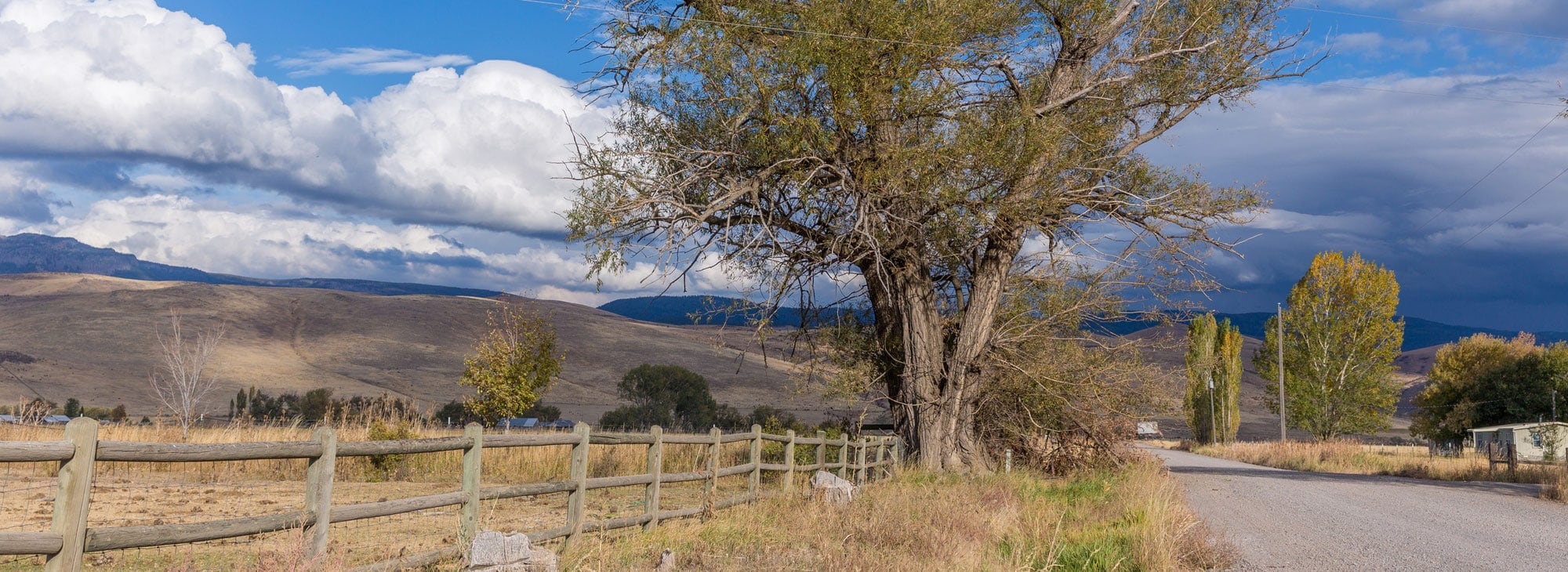 Clouds part for blue skies above a desert landscape.
