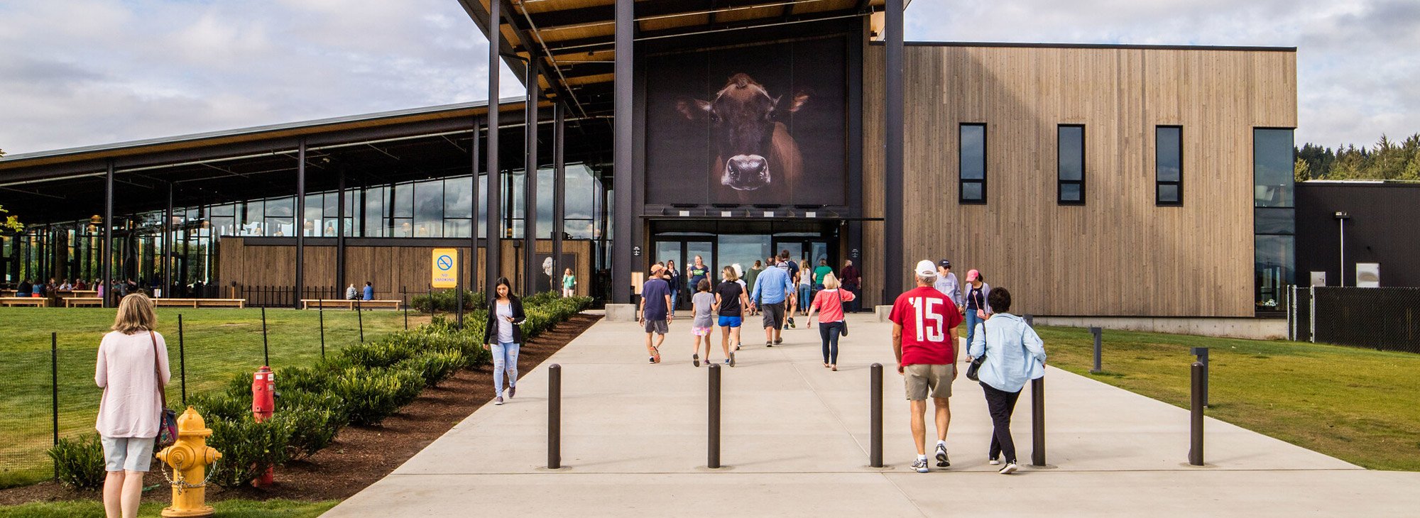 People walk in and out of large building