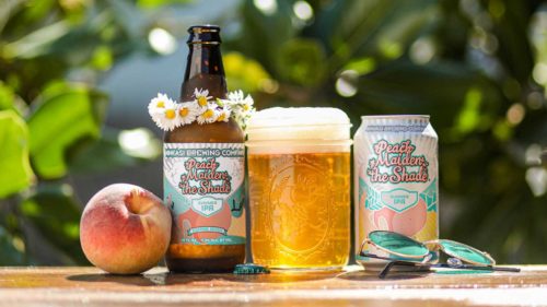 A peach, a bottle with a flower crown, a mason jar of beer, and a can.