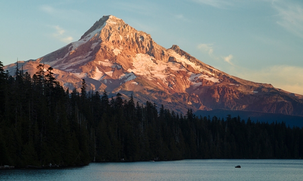 Mount Hood looms large above a lake at sunset