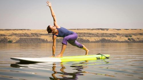 Paddleboarding improves your body's core strength, which is a key component of yoga. (Photo credit: Float On SUP Yoga)
