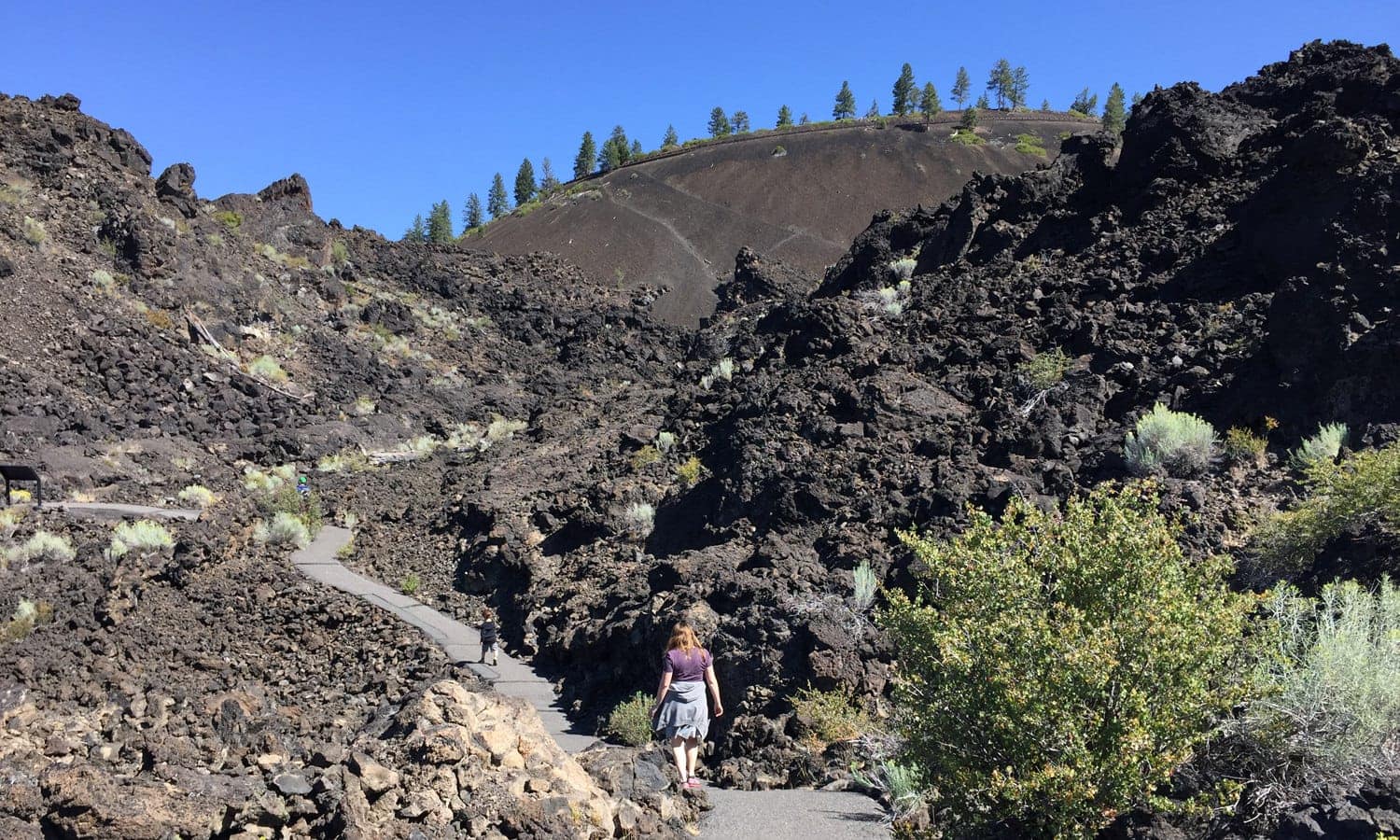 Family walking the path through Lava Lands
