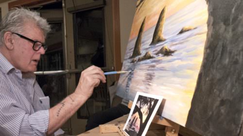 Artist and Cannon Beach gallery owner Blue Bond works on a painting at at the Arts in Action event.