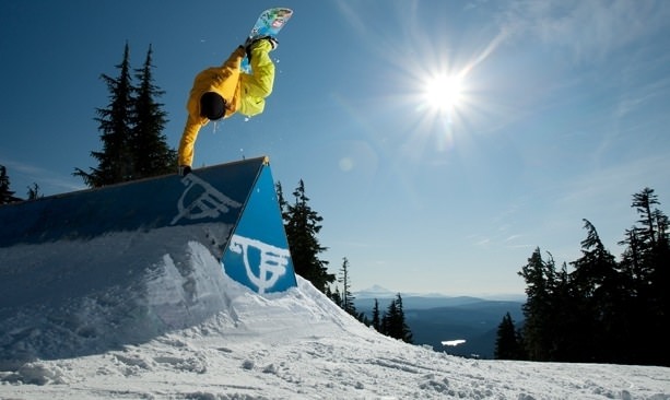 Snowboarder touches Timberline ramp from air