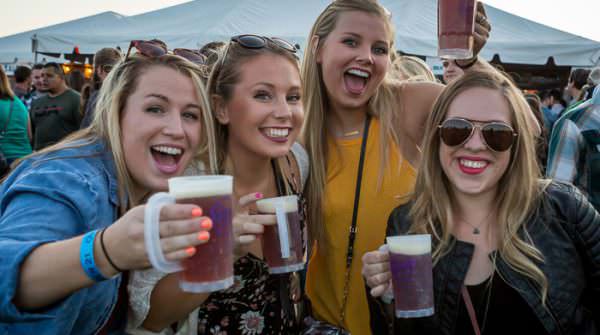 Blonde girls smile for camera at Bend Brewfest
