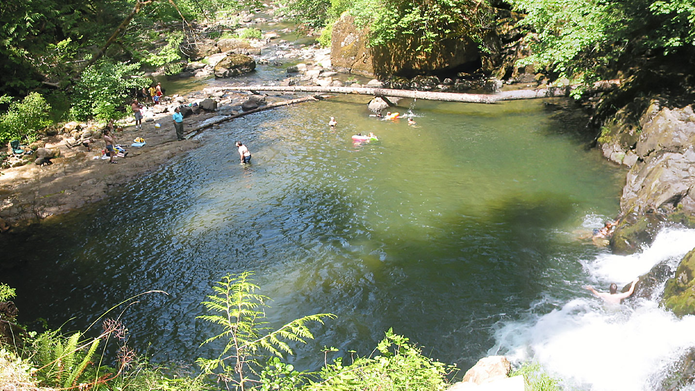 people swimming in large green lake