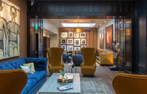 Yellow couches in the lounge of Hotel Lucia bring warmth to the room.