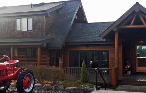 A red tractor sits in front of the picturesque Sakura Ridge bed & breakfast.