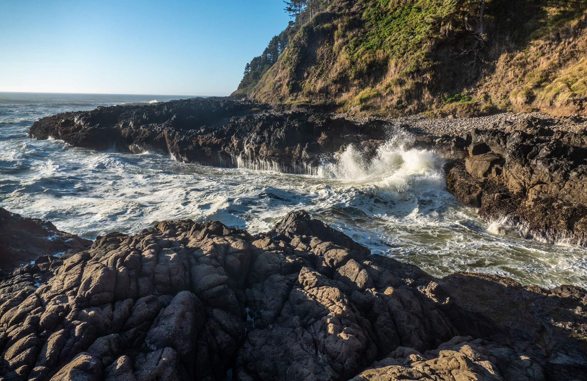 Waves crash through Devil's Churn at Cape Perpetua Scenic Area
