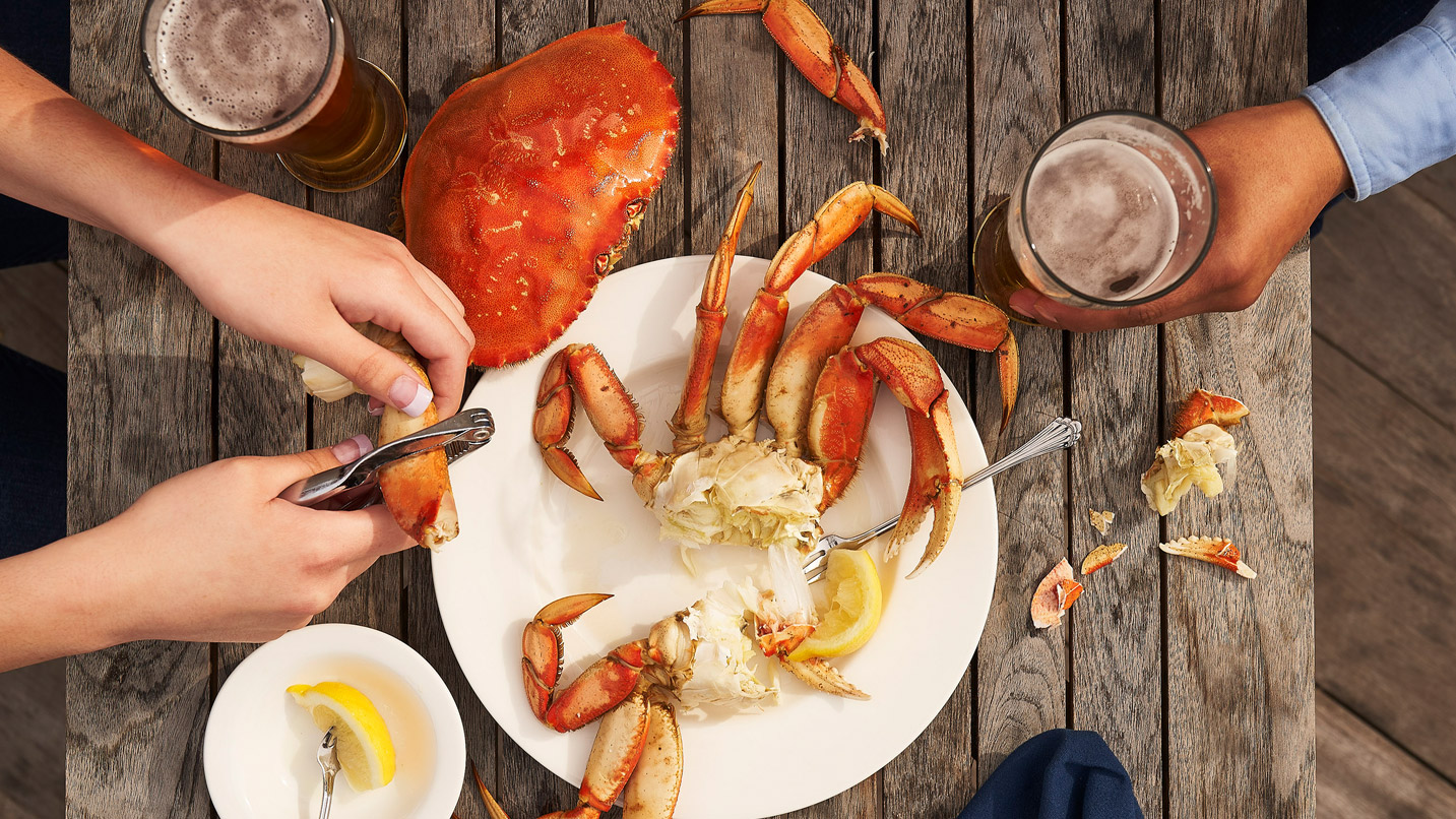 Diners cracking a crab open.