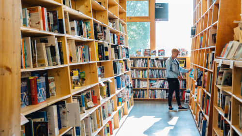 A person peruses the many books of Powell's.