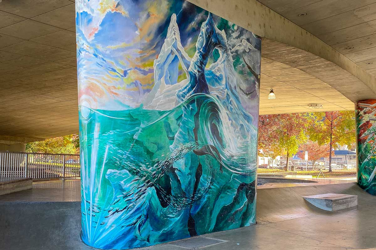 A pillar for the skatepark is decorated in art.