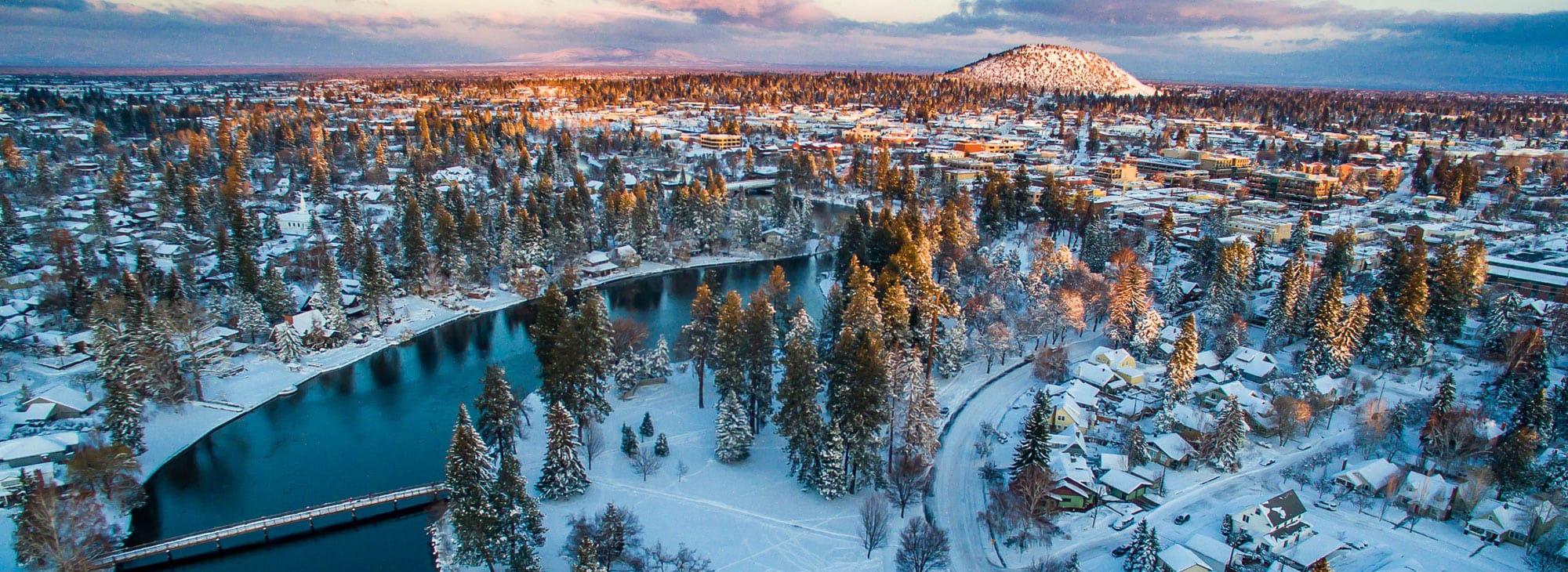 Sun setting on a snowy overview landscape in Bend