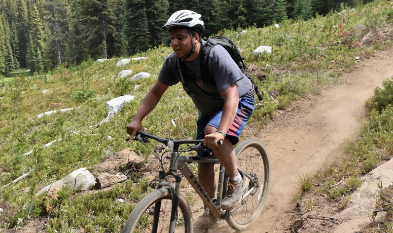 A cyclist biking a mountain bike trail