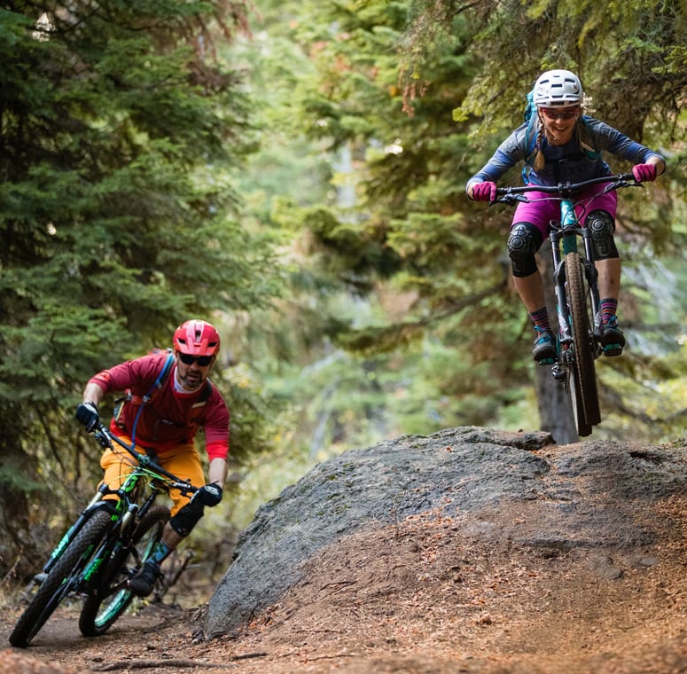 Two people mountain biking