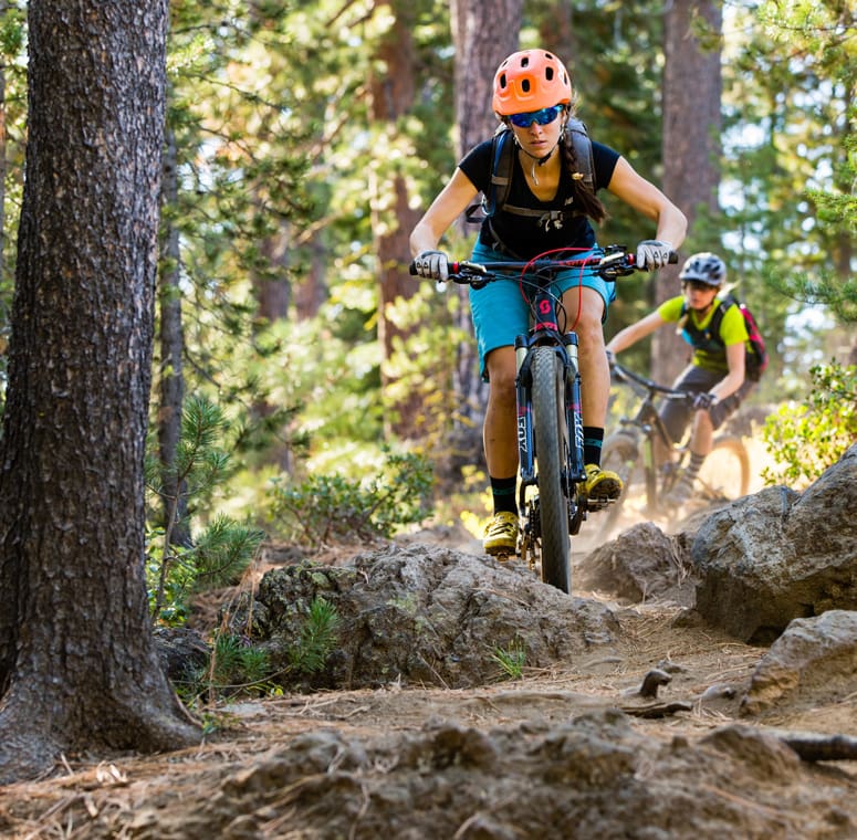 Two people mountain biking