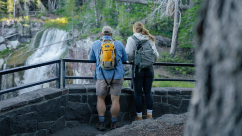 Two people overlooking a waterfall.