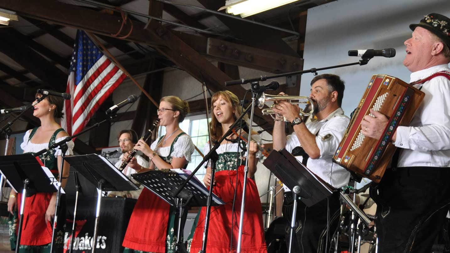 A polka band performs in traditional Bavarian attire.