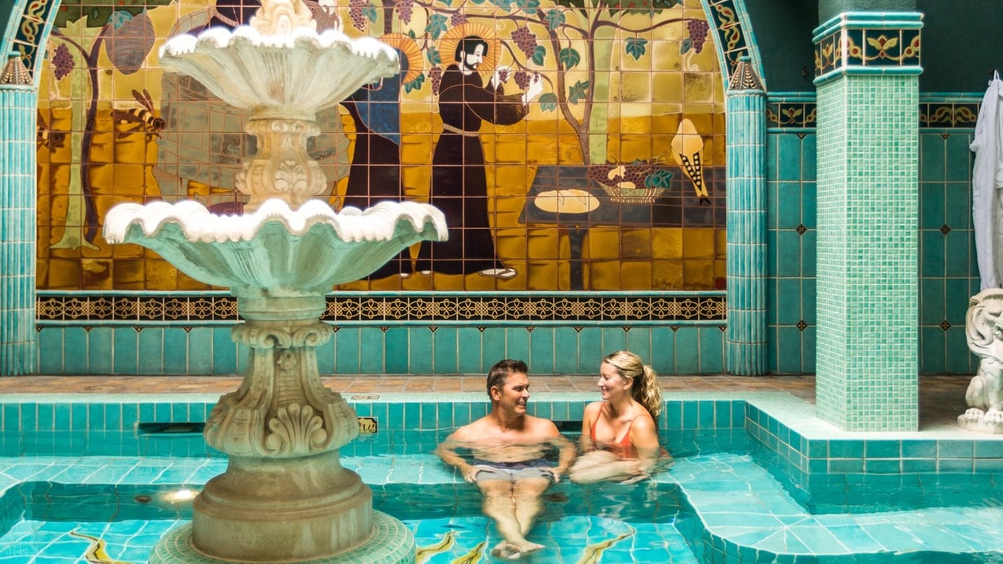 A man and woman sit in a hot tub