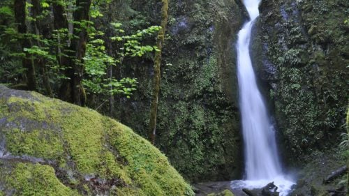 A waterfall flows onto rocks
