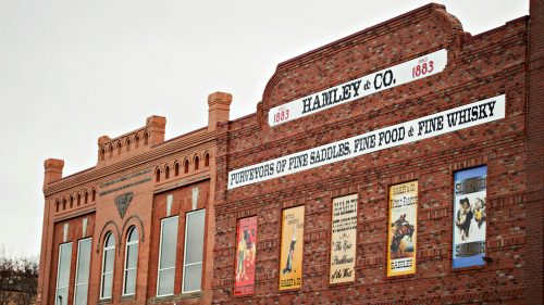 Outside Hamely & Co. are retro signs hanging from the brick walls.