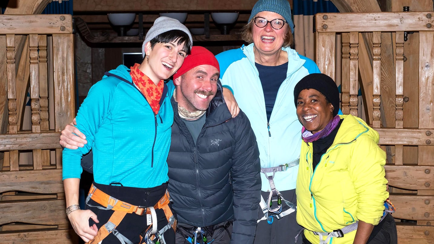 Four people pose inside Timberline Lodge