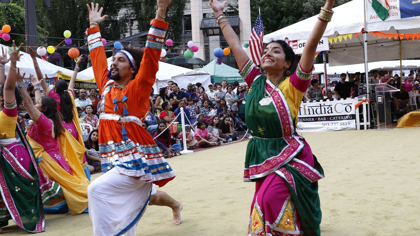 People dressed in traditional Indian clothing dancing