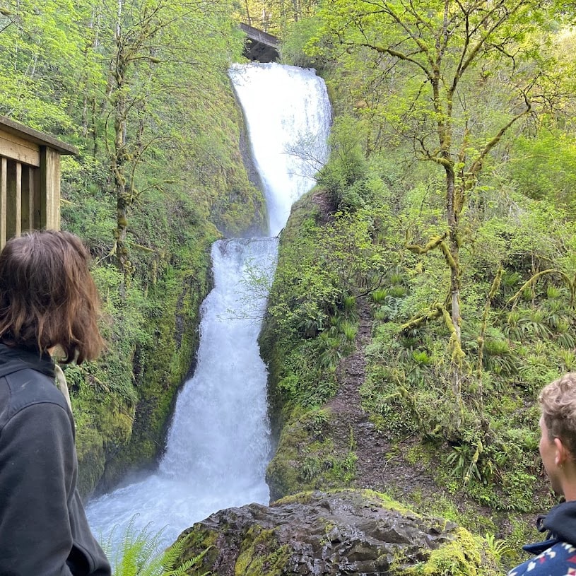 two people look at waterfall
