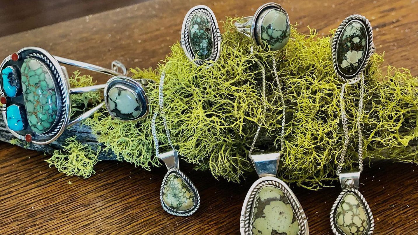 Several pendants sit on a piece of green moss