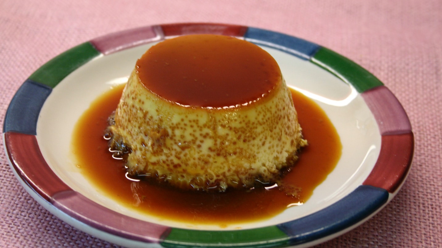 A serving of flan is on a plate