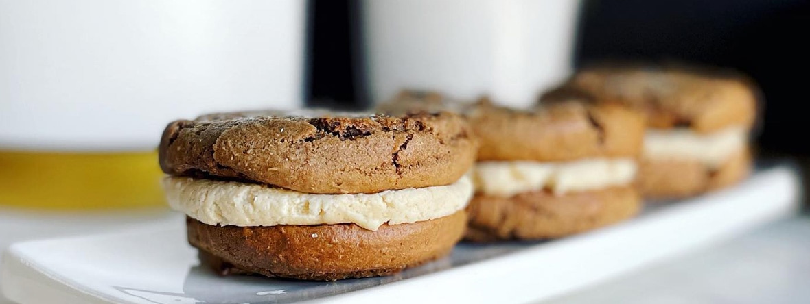 Three whoopie pies sit on a dish