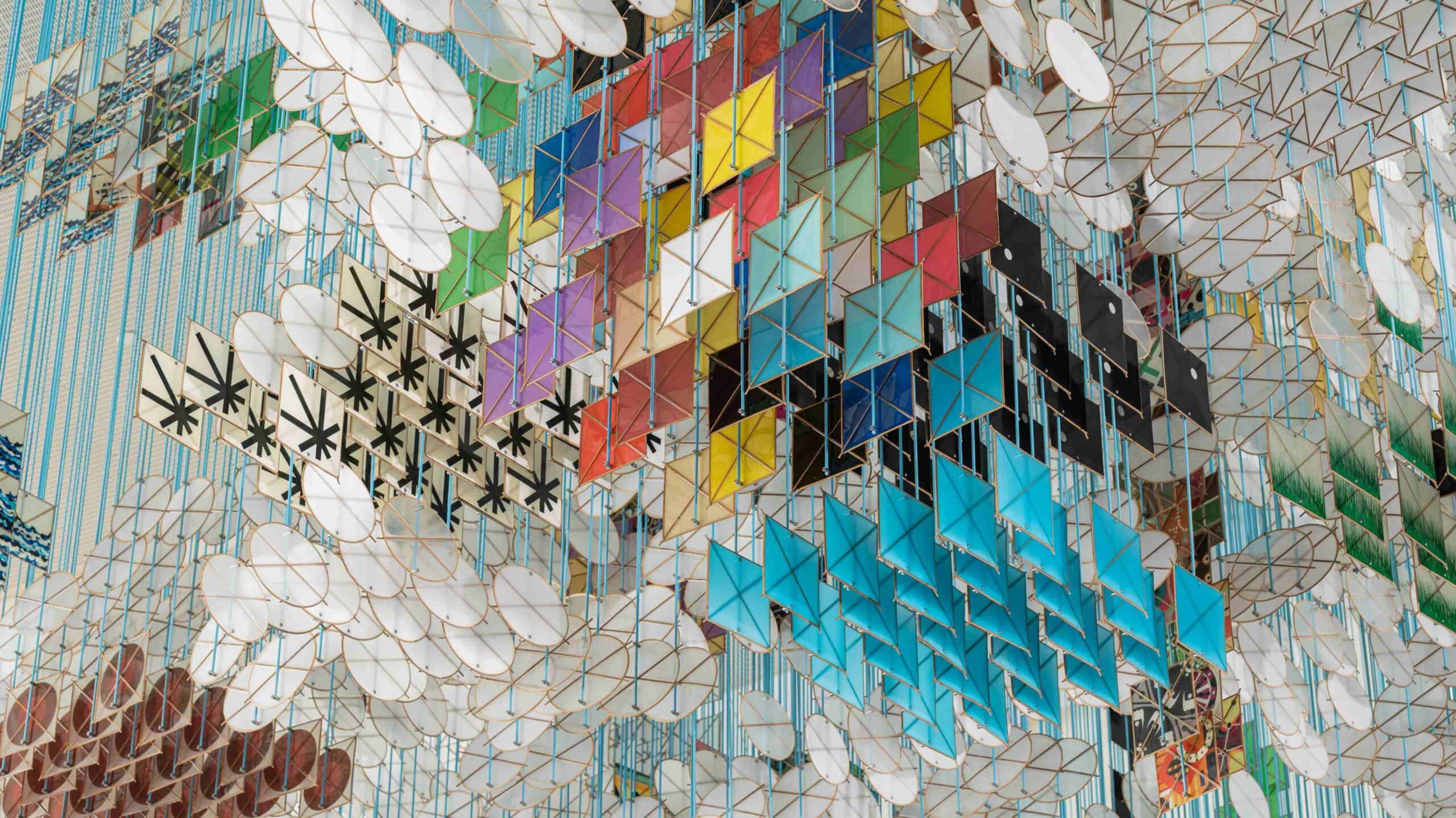 Colorful paper kites hang on a ceiling