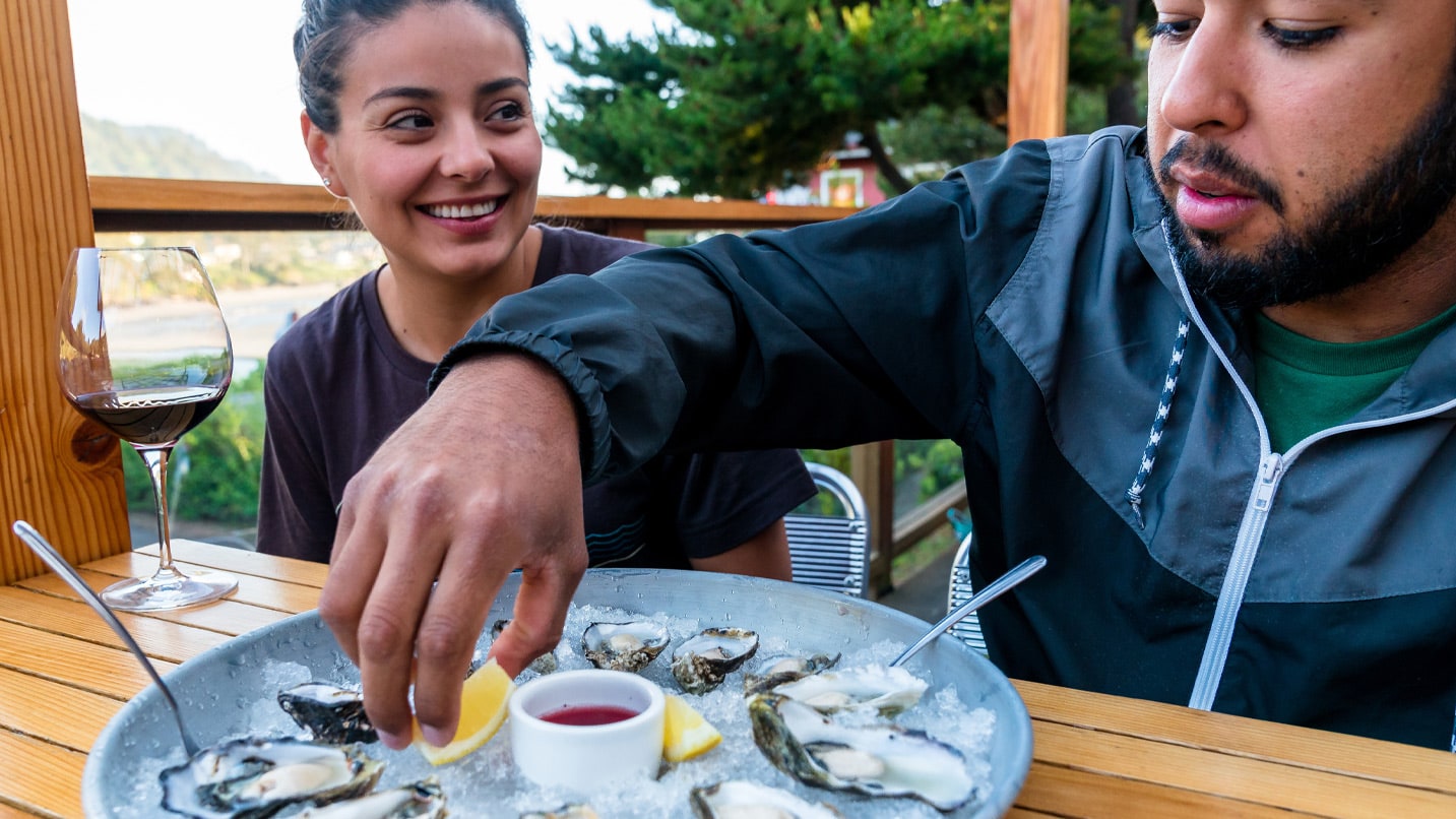 Two people and a plate of oysters