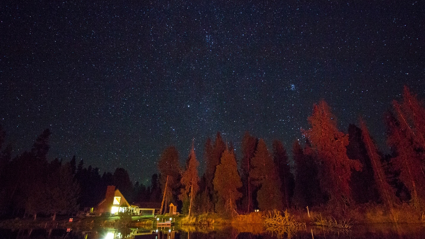 lit-up house under starry sky