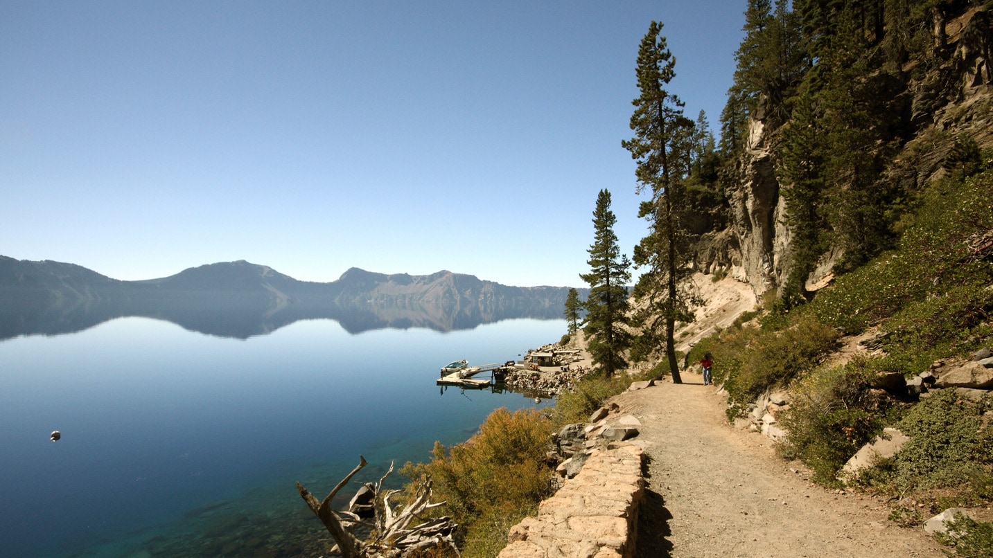 A trail leads down to a blue lake