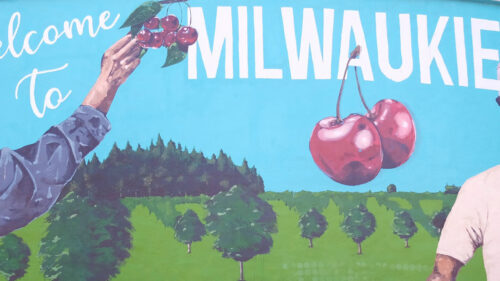 A mural shows three Black people and says Welcome to Milwaukie