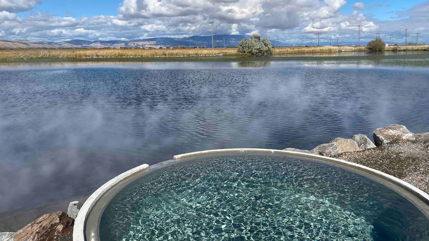 A sparkly hot tub sits at the edge of a lake