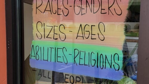 sign on door shows messages of pride