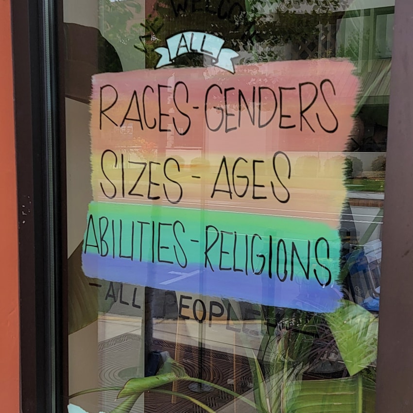 sign on door shows messages of pride