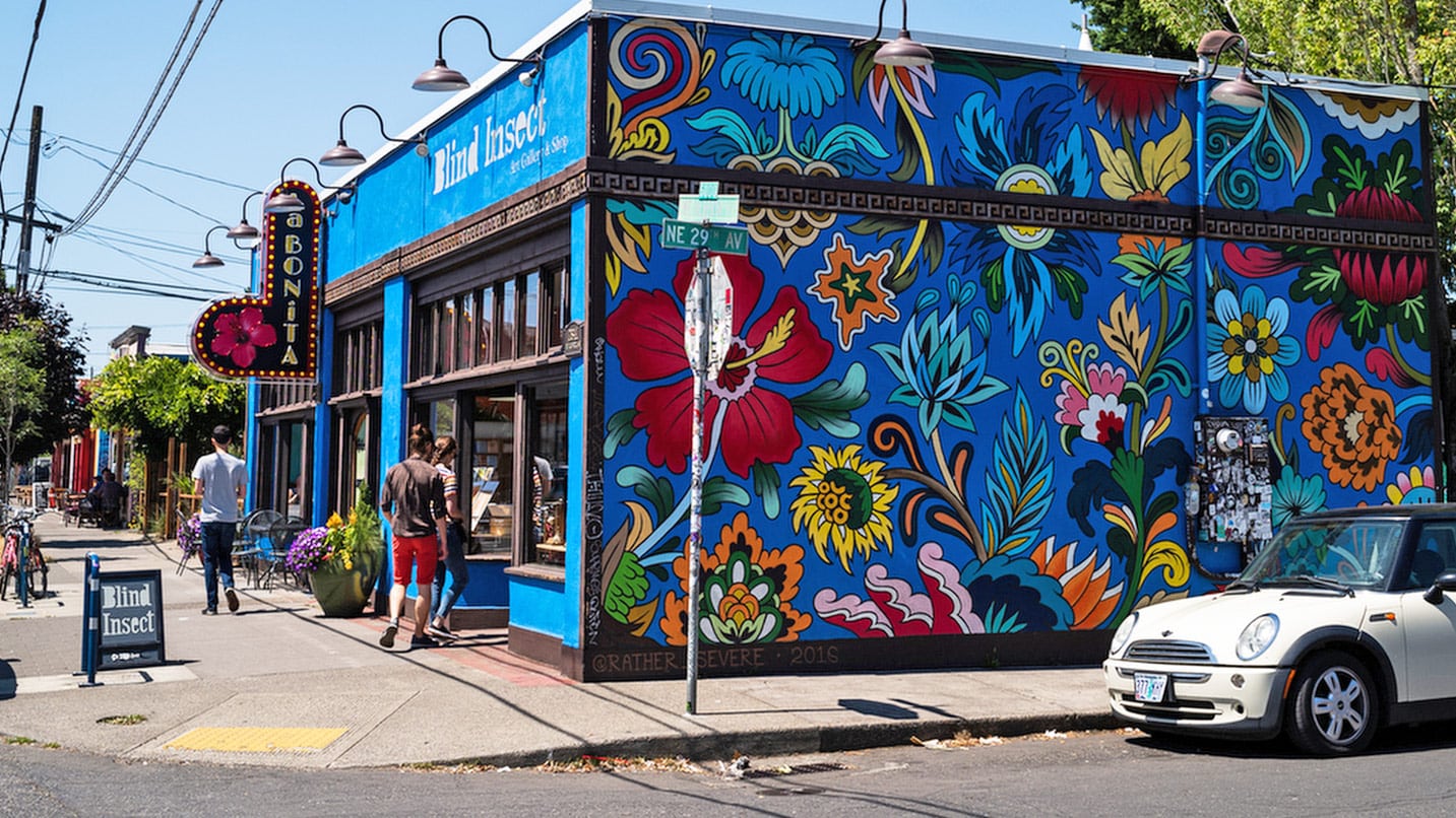 brightly painted mural on side of blue building