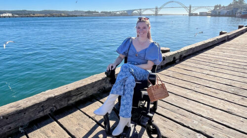 A well-dressed woman in a power wheelchair on the pier in Newport, Oregon.