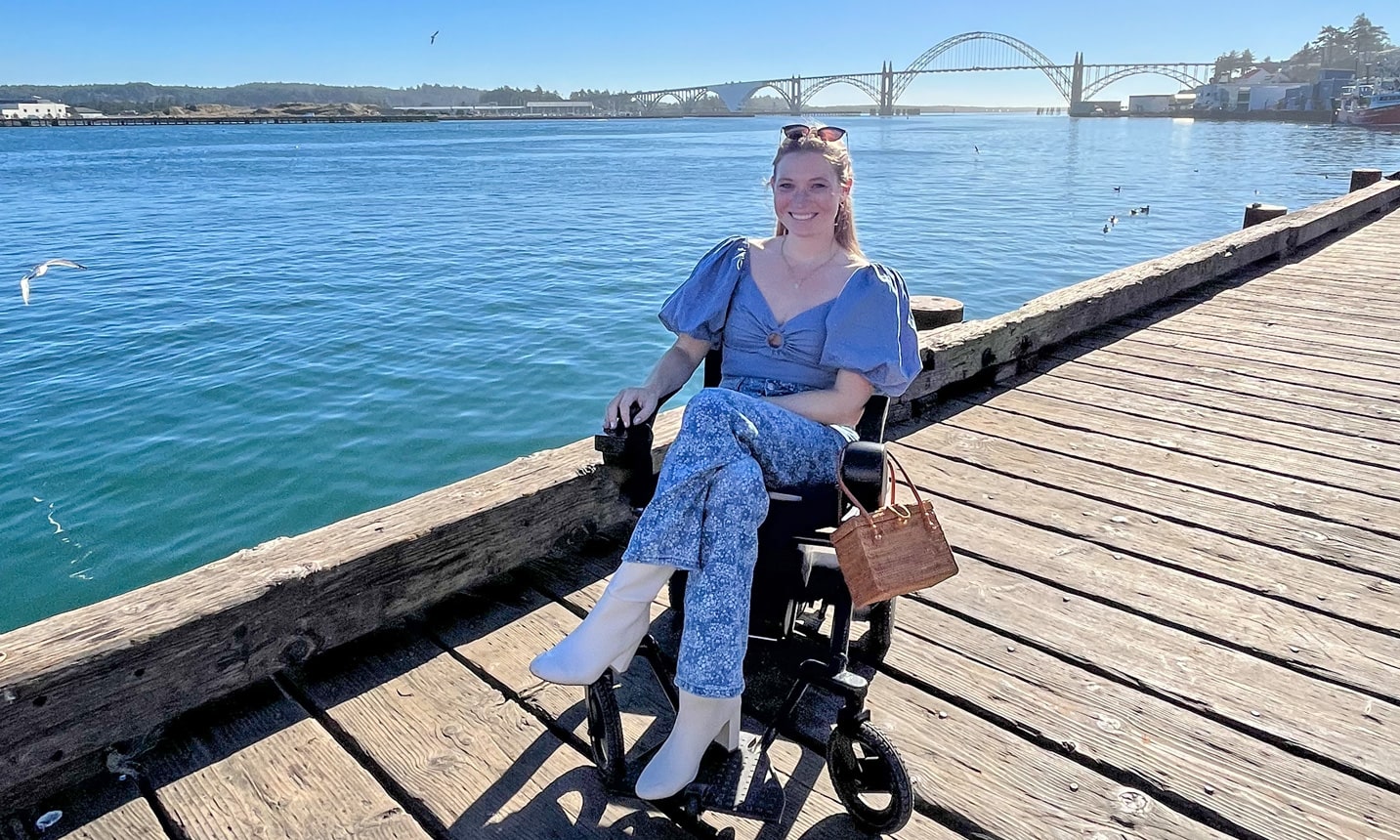A well-dressed woman in a power wheelchair on the pier in Newport, Oregon.