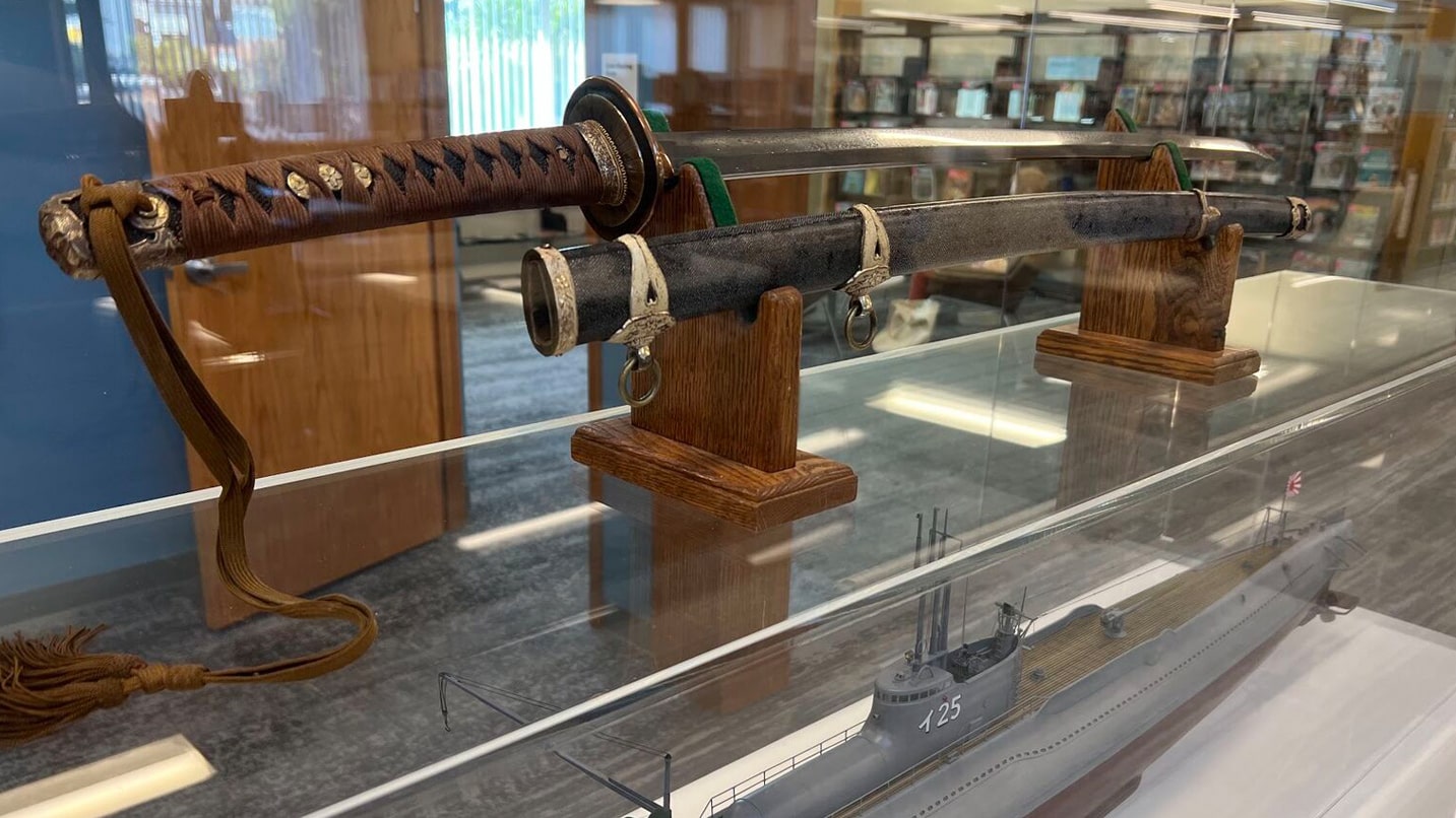 A traditional Japanese sword on display at a library.