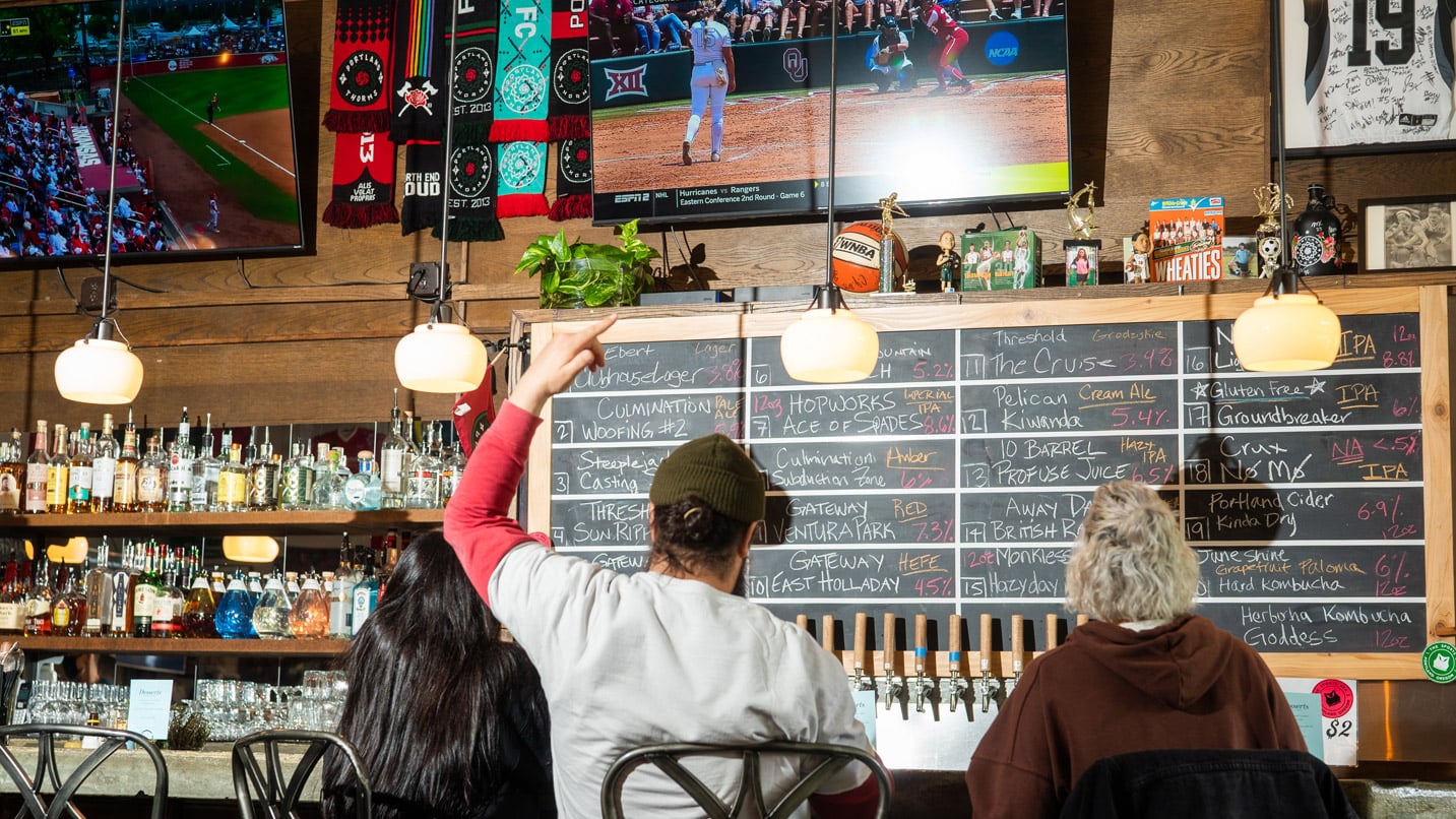 Interior shot of a bar showing women sports on TV.