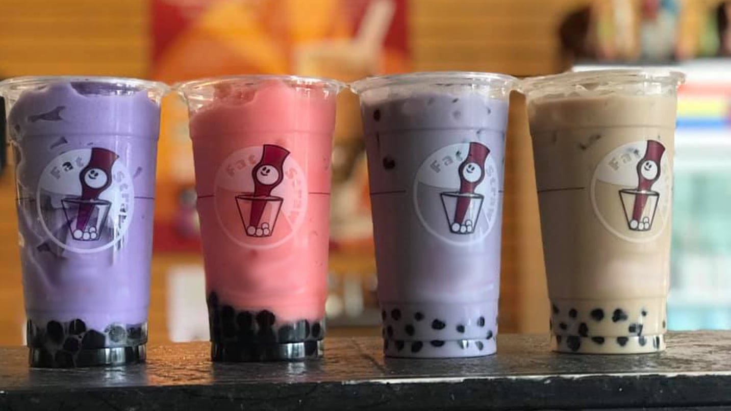 Four boba tea cups in varying flavors.