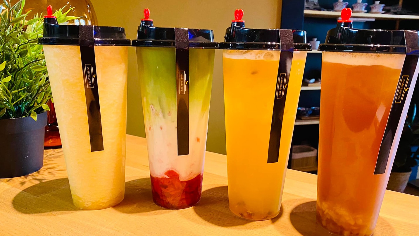 Four boba tea cups in varying flavors.