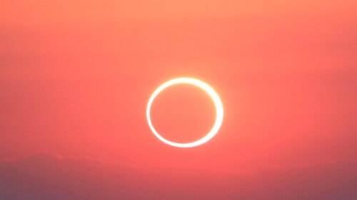 bright orange sky with thin white circular ring