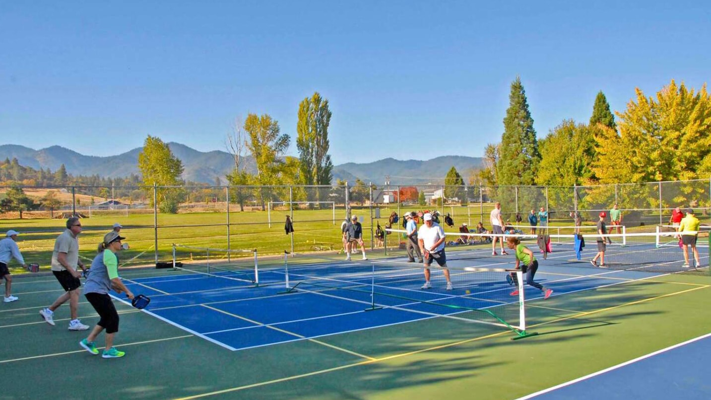 Pickleball players at outdoor pickleball courts.