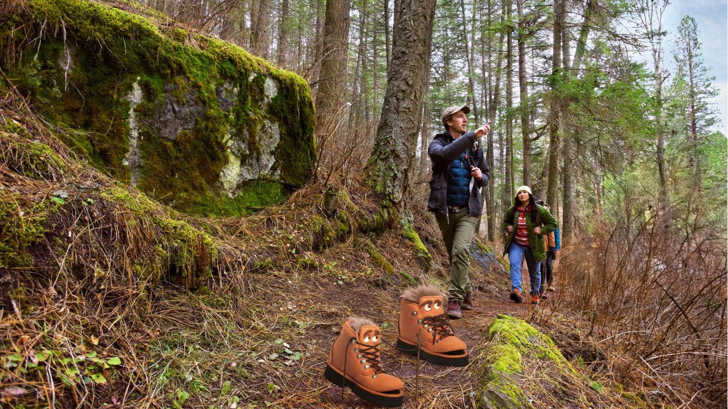 Puppet boots and two hikers on a forest trail.