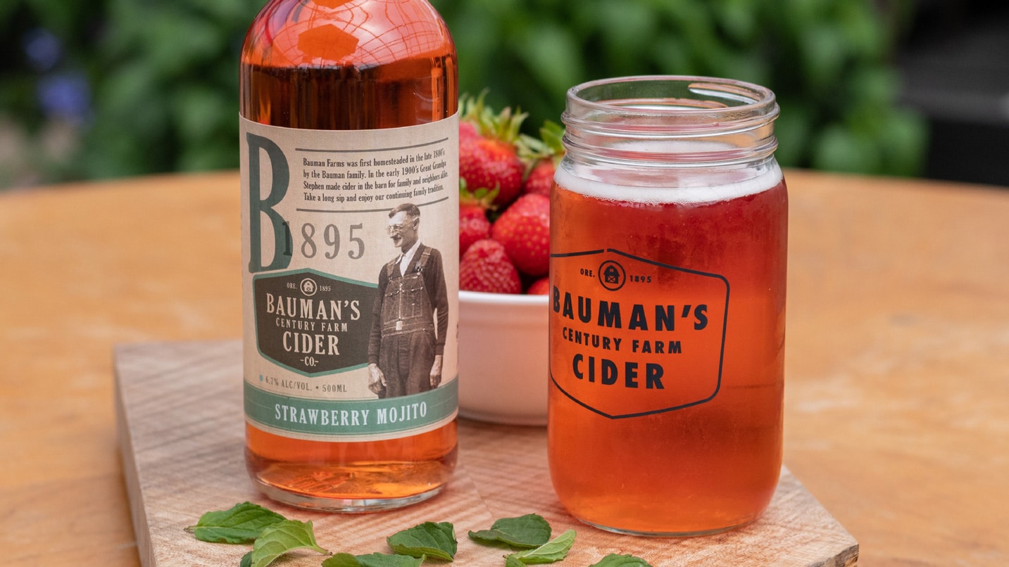 Clsoe up of a bottle of Bauman cider and a poured glass.